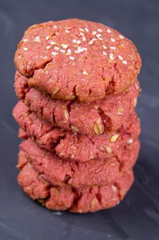 Oatmeal and beet cookies, on a on black wooden table. Food, holiday, cooking, baking background. Concept of home and healthy eating. Front views