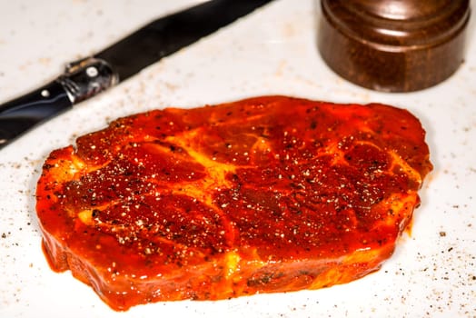 raw marinated pork neck with pepper
