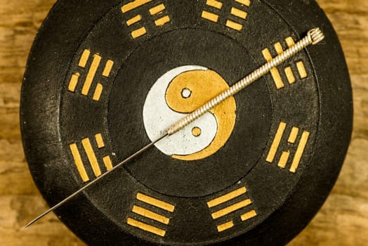 acupuncture needle on Chinese Taoism symbol