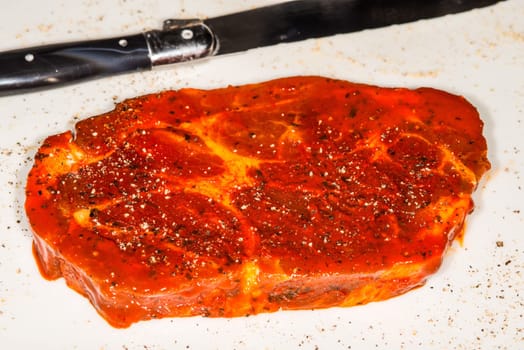 raw marinated pork neck with pepper