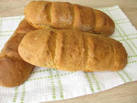 Freshly baked baguette on a dishtowel