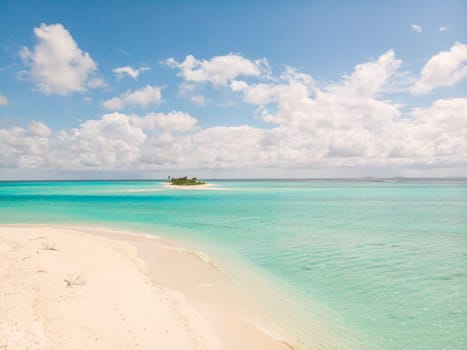 Picture perfect beach and turquoise lagoon on small tropical island on Maldives.