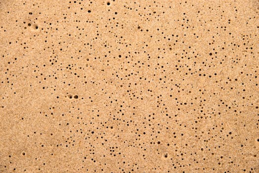 Sand of a beach with rain holes