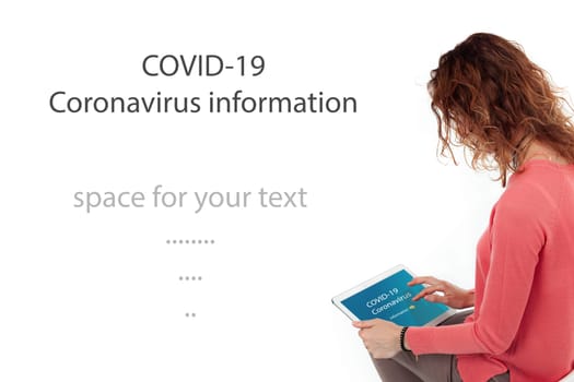 A woman facing her back looks into a tablet and watches information for coronavirus. Free space for your text.