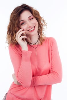 Portrait of cute joyful woman with trendy hairstyle wearing basic t-shirt talking on mobile phone isolated over white background.