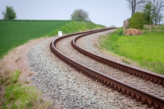 A large long train on a train track with trees in the backgroundundefined