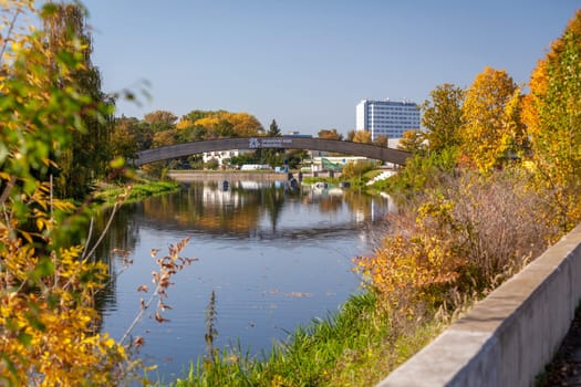 A wooden bridge over a body of water - city Pardubice, river Chrudimka, park Na Spici, autumn day
