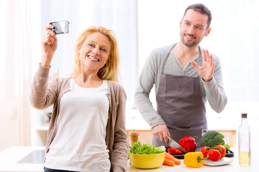 View of a Young attractive woman taking selfie in kitchen