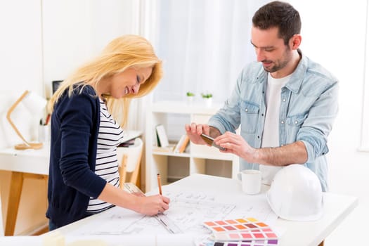 View of Two attractives architect working at the office
