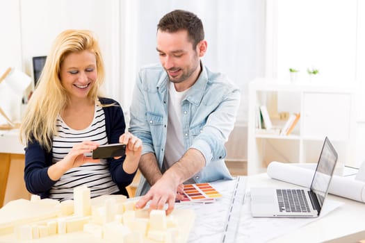 View of Two attractives architect working at the office