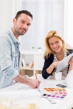 View of Two attractives architect working at the office