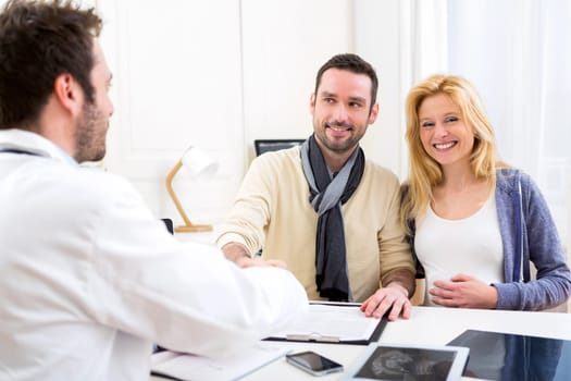 View of a young attractive futur dad hand shaking with the doctor