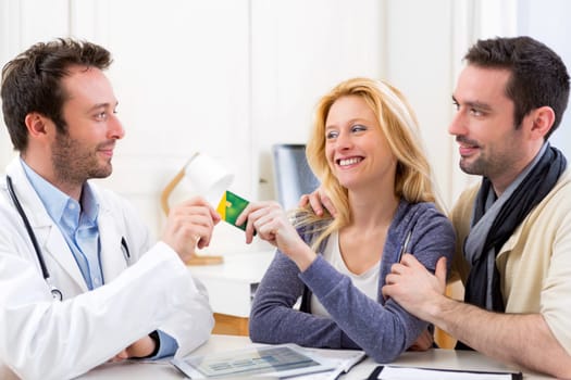 View of a Young attractive couple handling a social insurance card