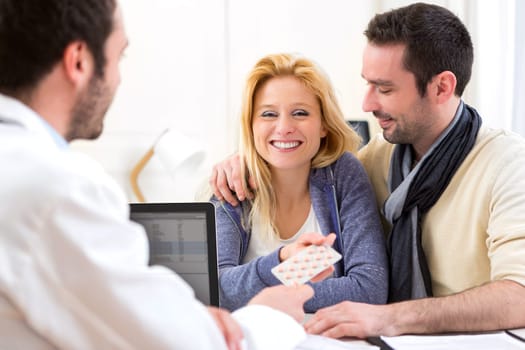 View of a Doctor gives pills to couple of patient