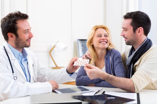 View of a Doctor gives pills to couple of patient