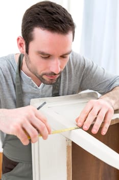 View of a Young attractive carpenter working in his workshop