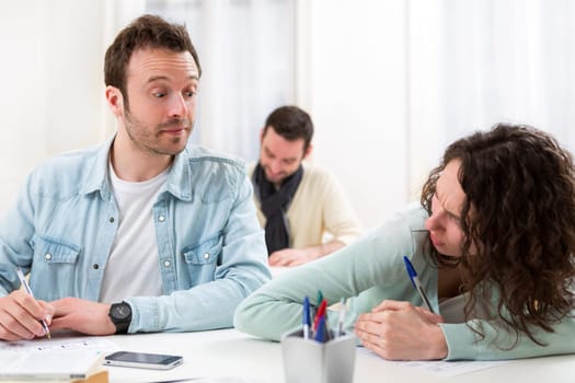 View of a Classmate try to cheat on his neighbour