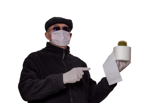 Coronavirus quarantine cocept. Man with surgical mask, hood, glasses and medical gloves shows a roll of toilet paper with an abstract model of a virus covid-19 on it isolated on a white background.