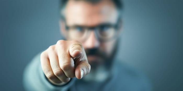 Man points accusingly, likely addressing a specific issue or person. Focus on the finger, not the face.