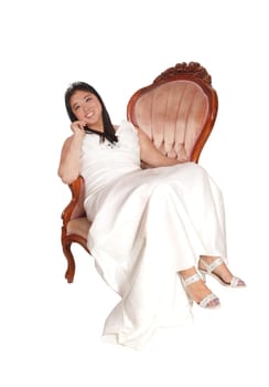 A beautiful young Chinese bride sitting in a old fashion armchair in a .white dress, isolate for white background.