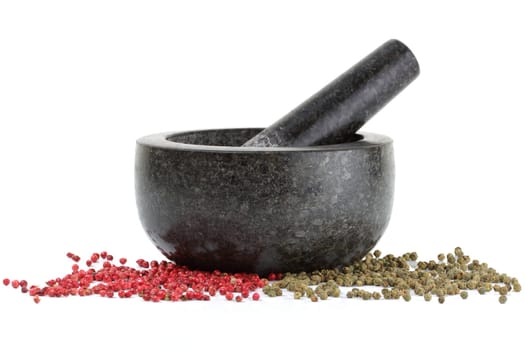 A side view of peppercorns with mortar and pestle isolated on white
