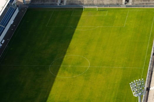 Lawn of a soccer stadium with floodlight from above