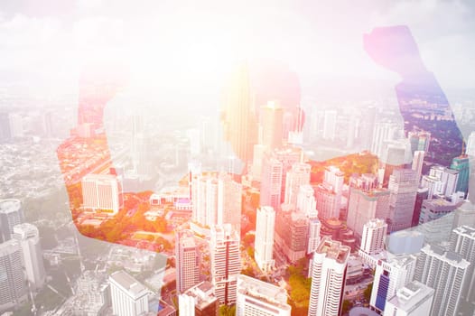 Double exposure image of excited business man celebrating success overlay with cityscape.