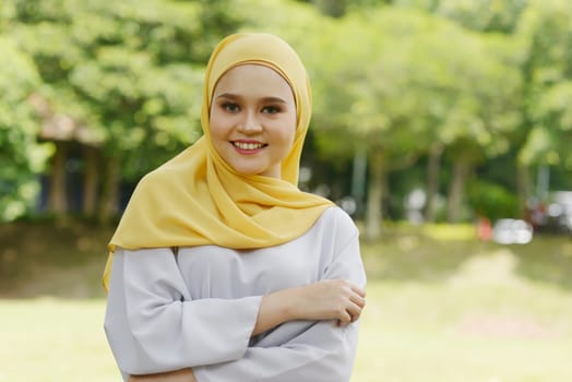 Portrait of cheerful Muslim girl in hijab, smiling at outdoor.
