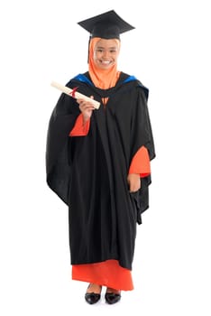 Full body female student in graduation gown, standing isolated white background.