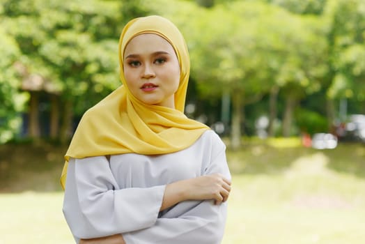 Portrait of cheerful Muslim girl in hijab, smiling at outdoor.