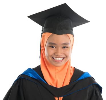 Female student in graduation gown, standing isolated white background.