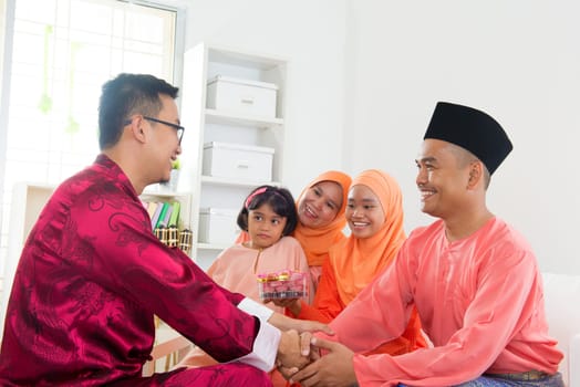 Friend visiting during hari raya open house. Malaysian people living lifestyle.