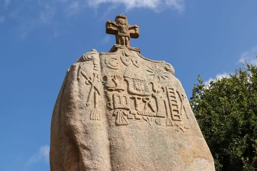 Menhir of Saint-Uzec. Menhir is about eight meters high and three meters wide. It is the largest menhir in France with Christian symbols. Pleumeur-Bodou, Brittany, France.