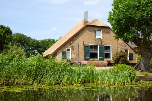 Traditional farm house on the river Graafstroom in the Netherlands..
