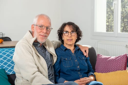 Senior couple relaxing on a sofa at home