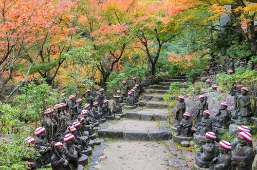 Autumn Japanese garden with Buddha lined up pathways at Daisho-in Temple grounds in Miyajima Island, Hiroshima, Japan