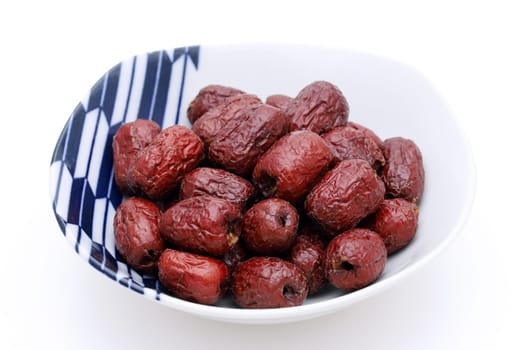 Jujube, Chinese dried red date fruits in a bowl on white background