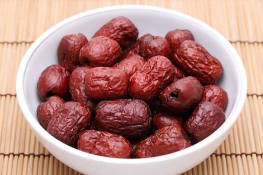 Dried Jujube, Chinese dried red date fruits in a bowl on bamboo table