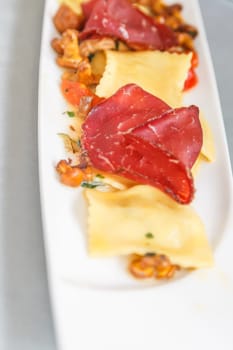 Starter, stuffed ravioli with mushrooms and ham.