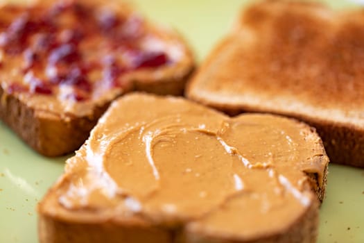 Toasted whole wheat bread slices with peanut butter and jelly
