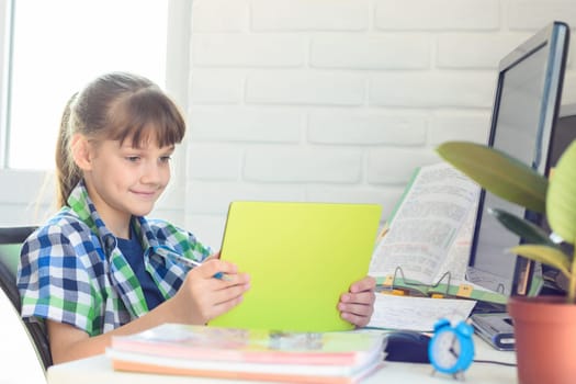 Girl watching video tutorials on a tablet while at home