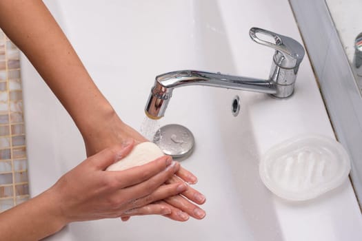 Girl soaping her hands with a soap