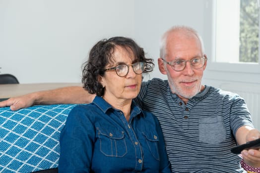 Senior couple relaxing on a sofa at home