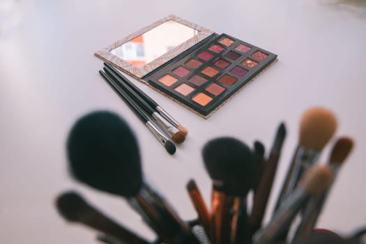 Makeup cosmetics tools background & beauty cosmetics, products & facial cosmetics package lipstick, eyeliner, concealer, mascara, eye shadow stick & highlighter palette on white color background.