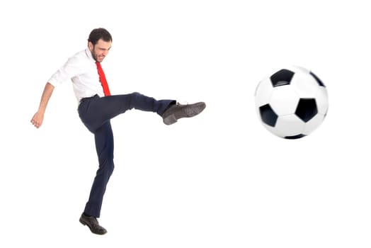 Businessman kicking a soccer ball isolated in white