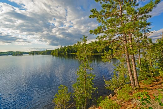 Sun and Clouds in the North Woods on Saganagons Lake in Quetico Provincial Park in Ontario