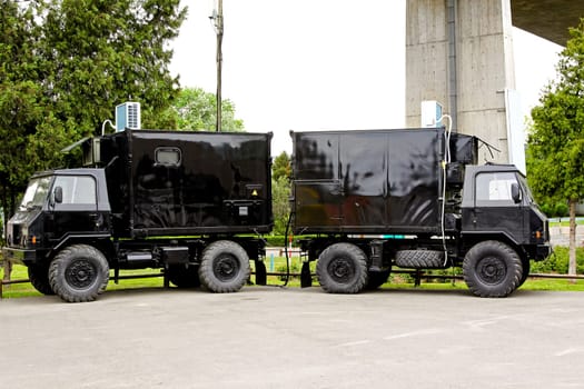 Two black off road trucks used for heavy terrain .