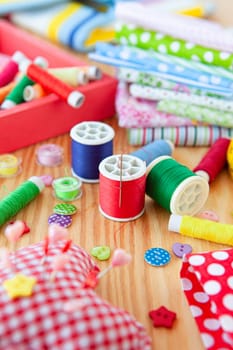 Colorful needlework utensils with cottan fabrics and yarns