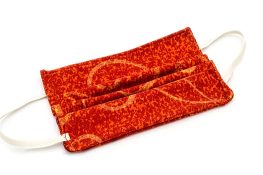 Still life of a red facial mask on a white background anti covid 19, DIY sewing project