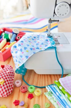 Colorful needlework utensils with cottan fabrics and yarns
